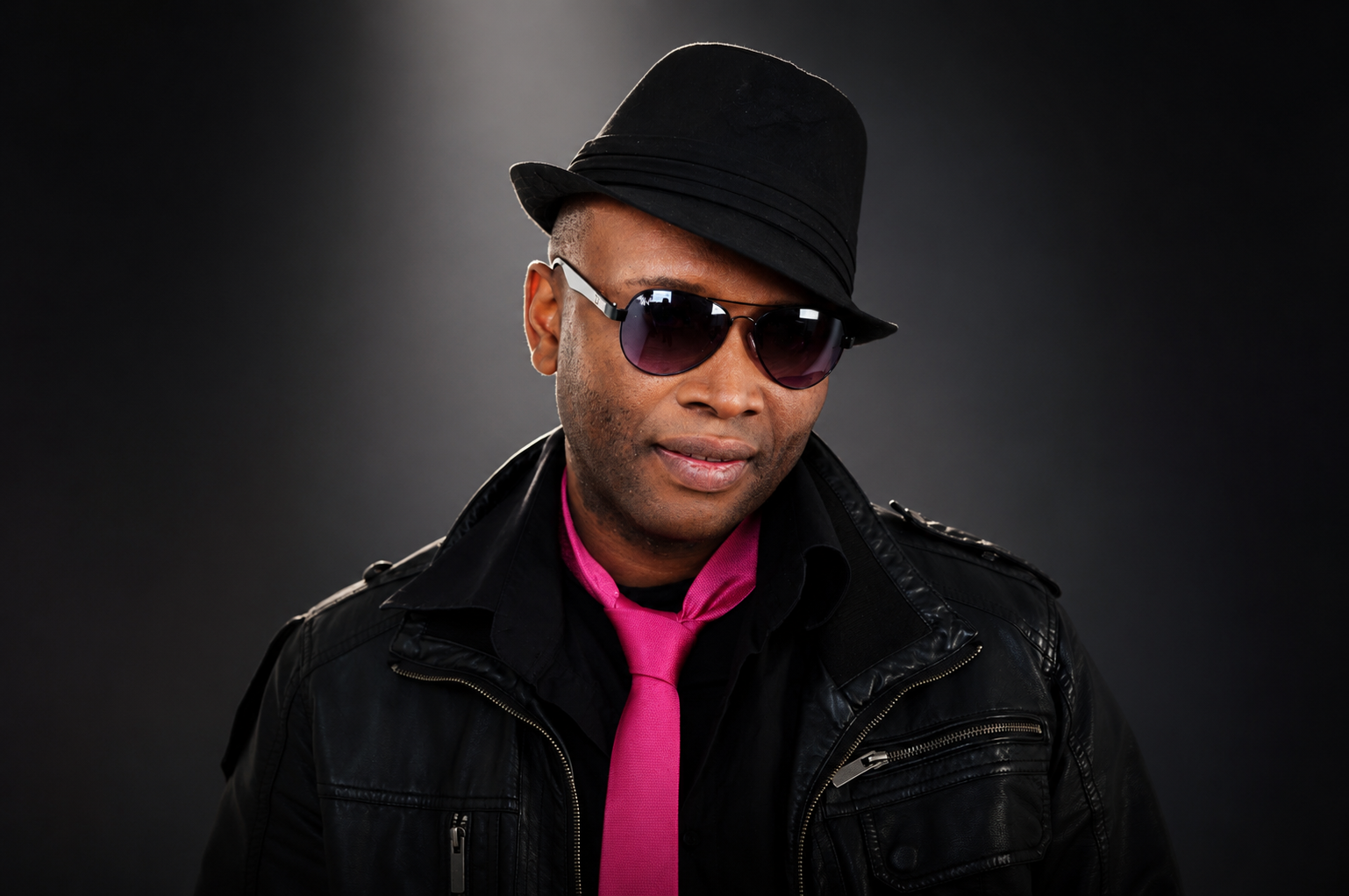 Mister Kibs in hat, sunglasses and pink tie