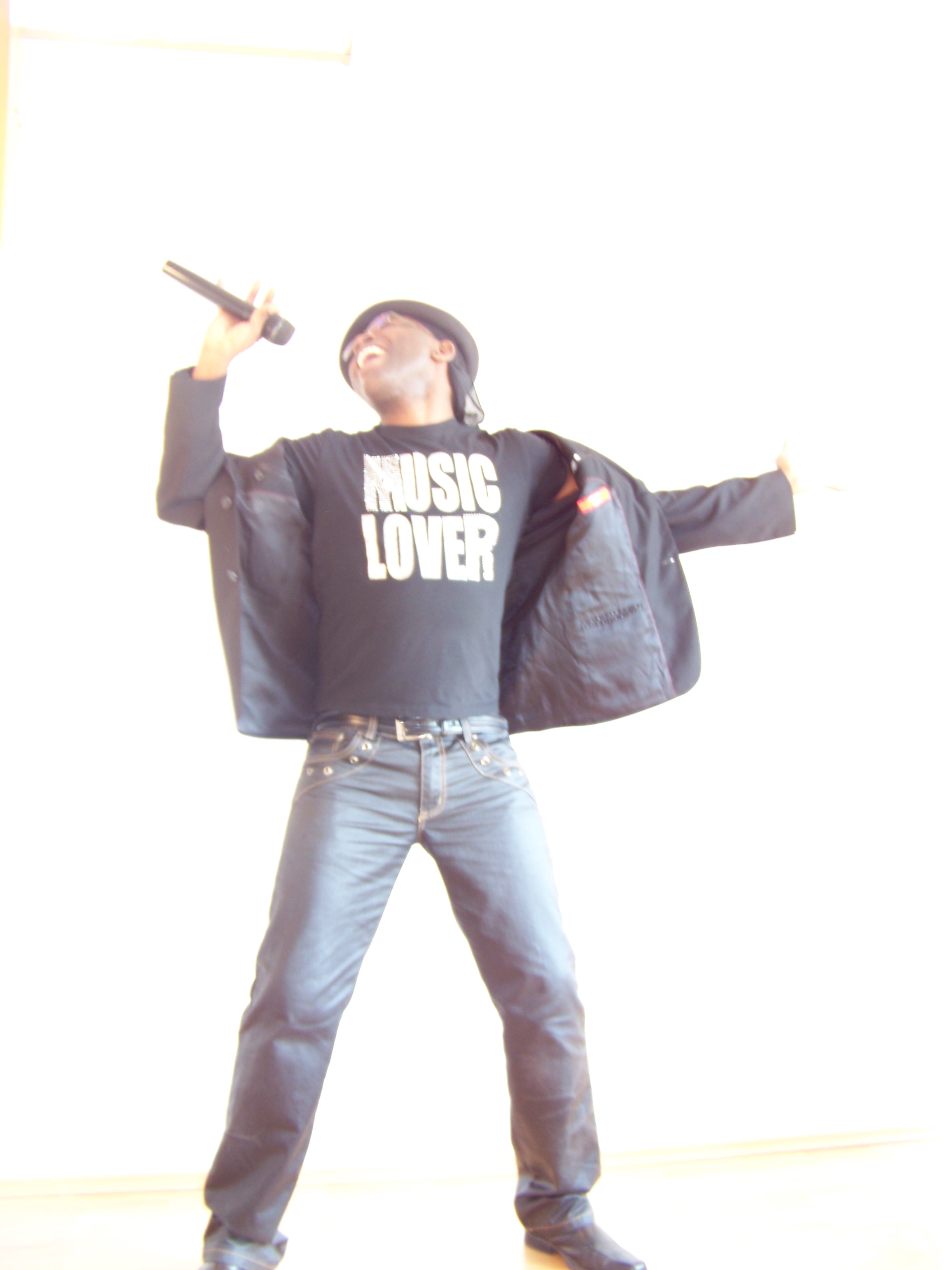 Mister Kibs dancing on a dark stage